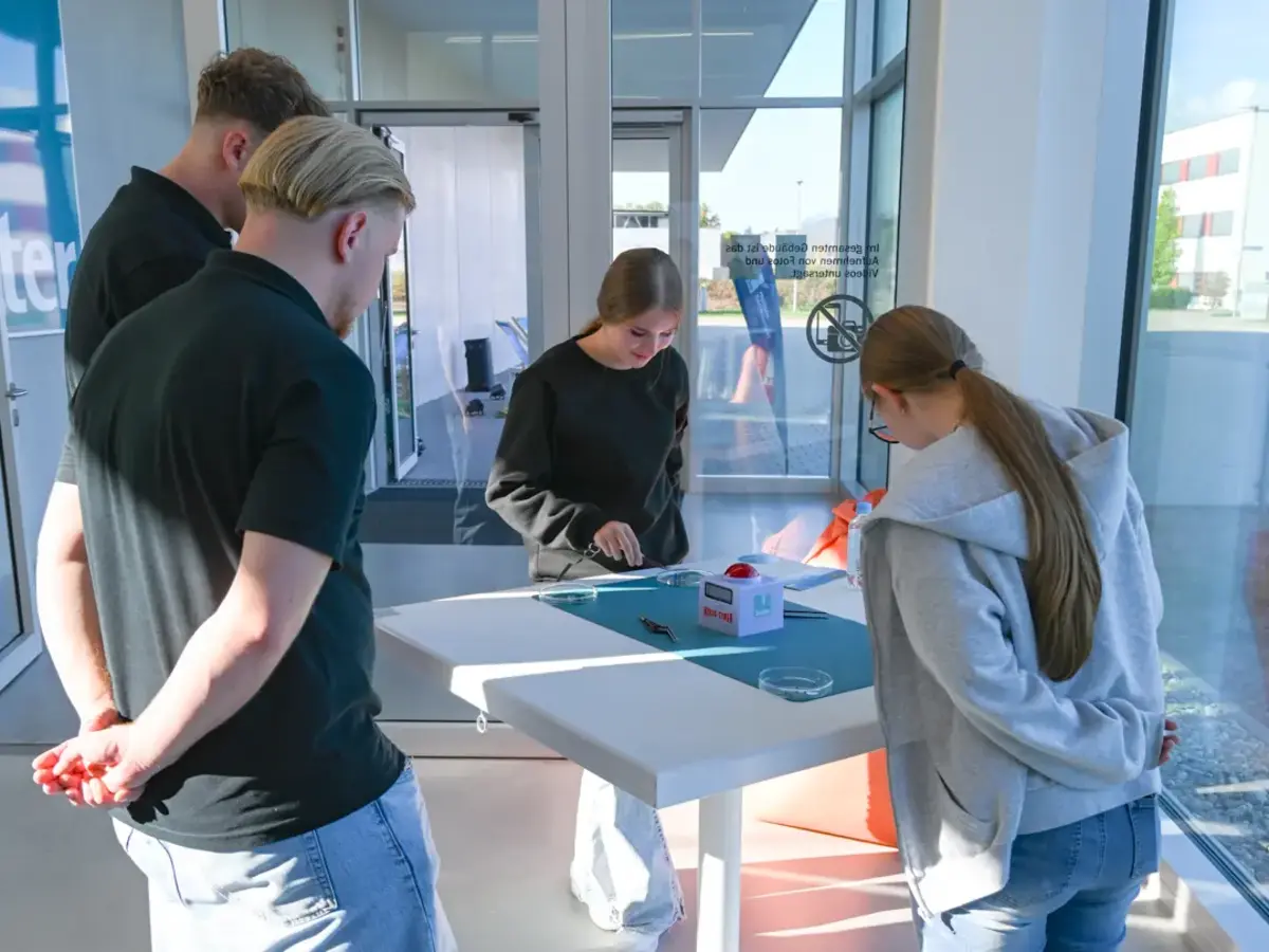 Visitors participating in an interactive hands-on activity during a vocational training event.