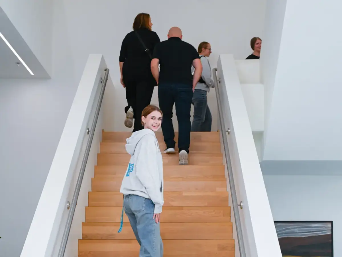 Visitor group taking part in a guided tour through a company building during a vocational training event.
