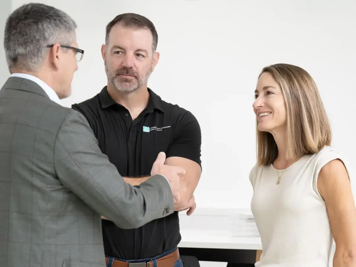 Three people having a business discussion during an informal meeting in a modern office
