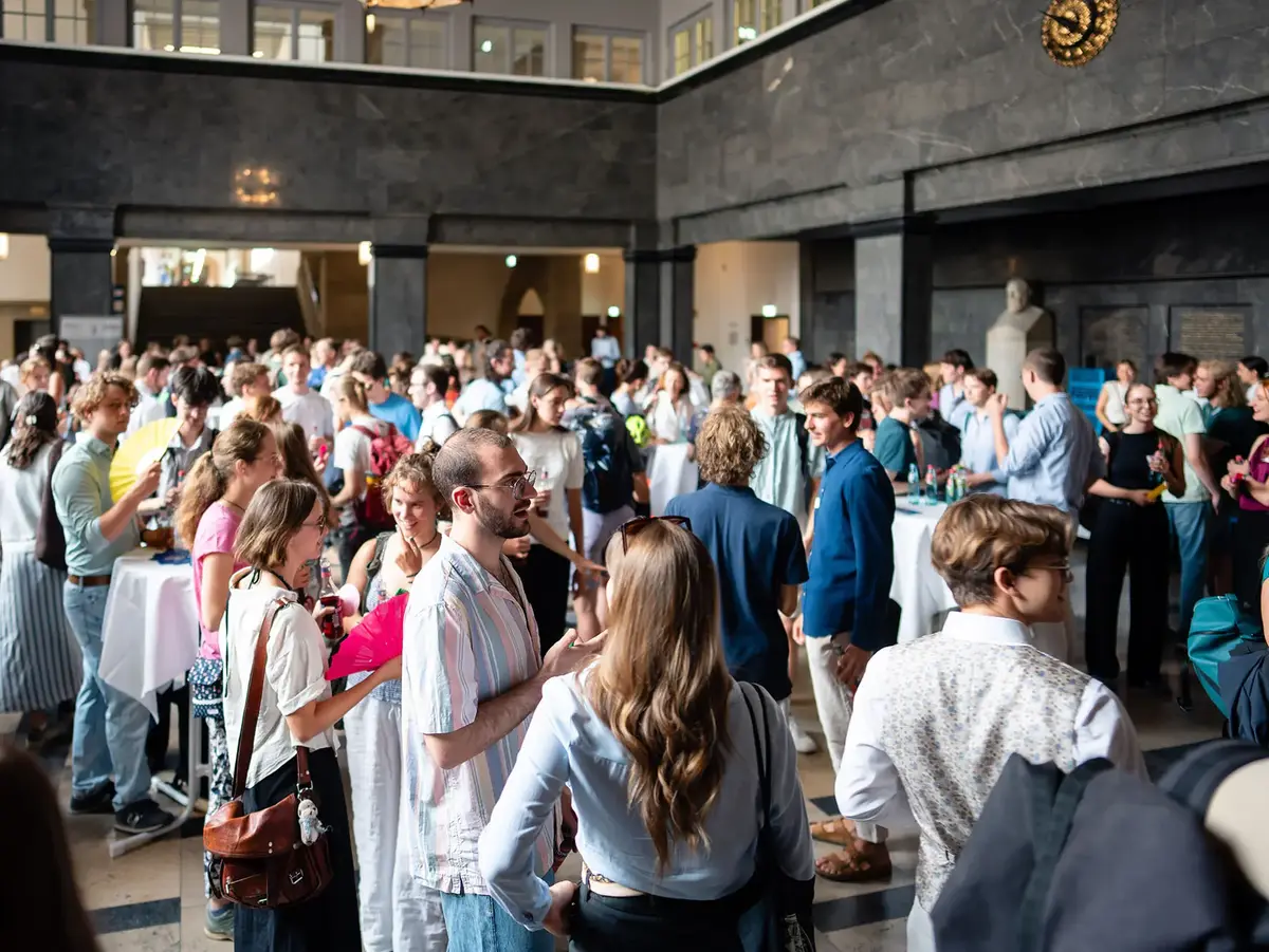 Networking event with numerous attendees gathered in a prestigious foyer. The image highlights professional exchange, collaboration, and personal interactions in a dynamic event setting.