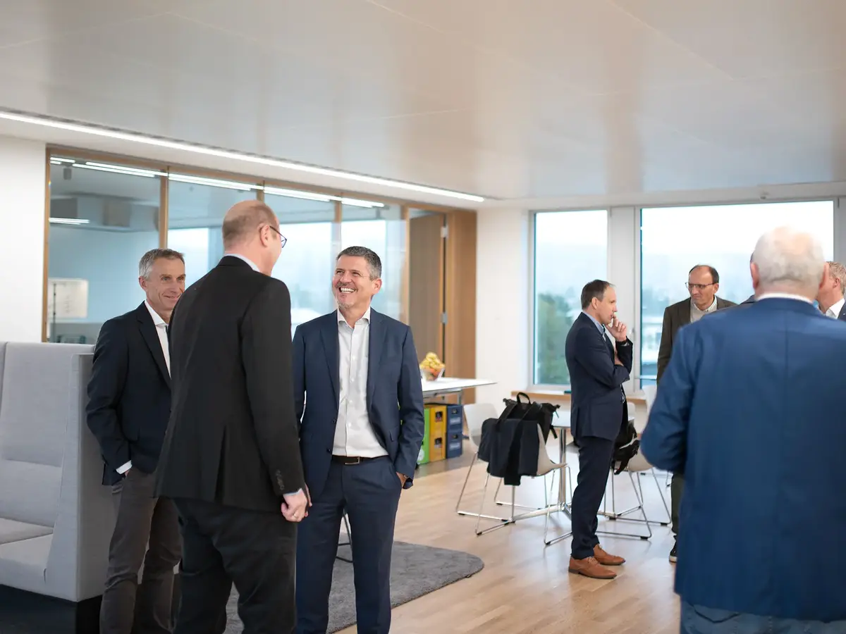 Participants of the wvib Medical Technology Cluster networking in a modern office environment.