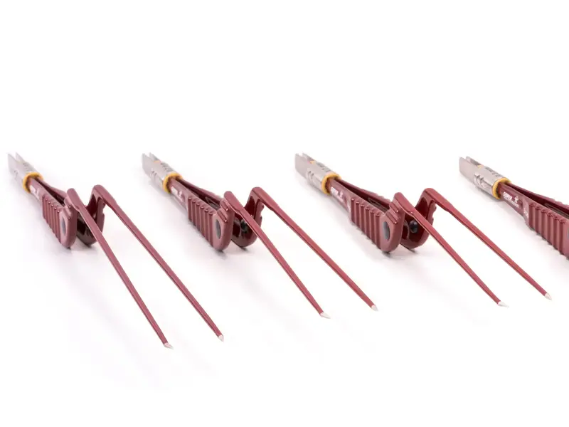 Four red SuperGliss non-stick zhora bipolar forceps in front view against a white background