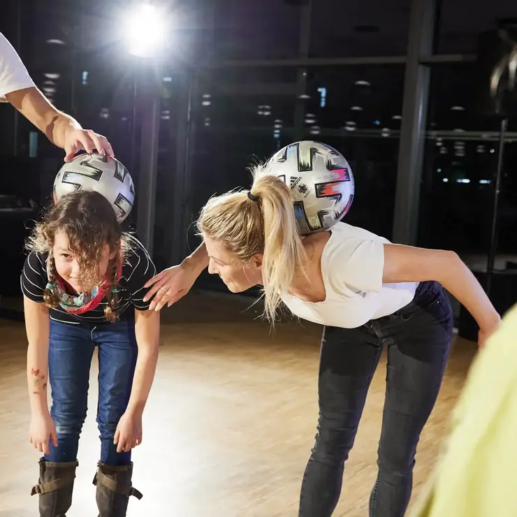 Several participants taking part in a team challenge during an event.
